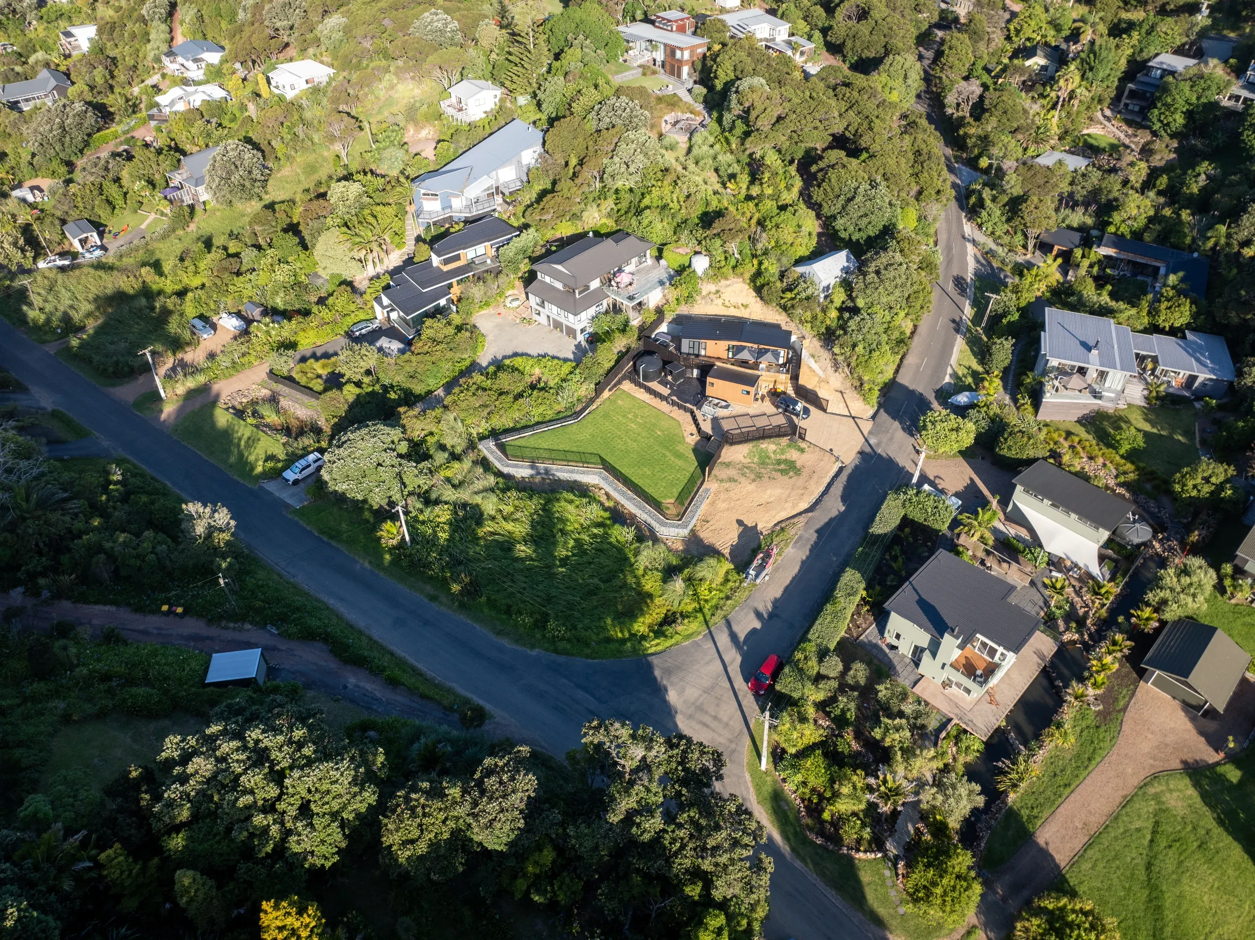 Top-down aerial of the completed section, the terrace reading as a clear level platform in the slope.