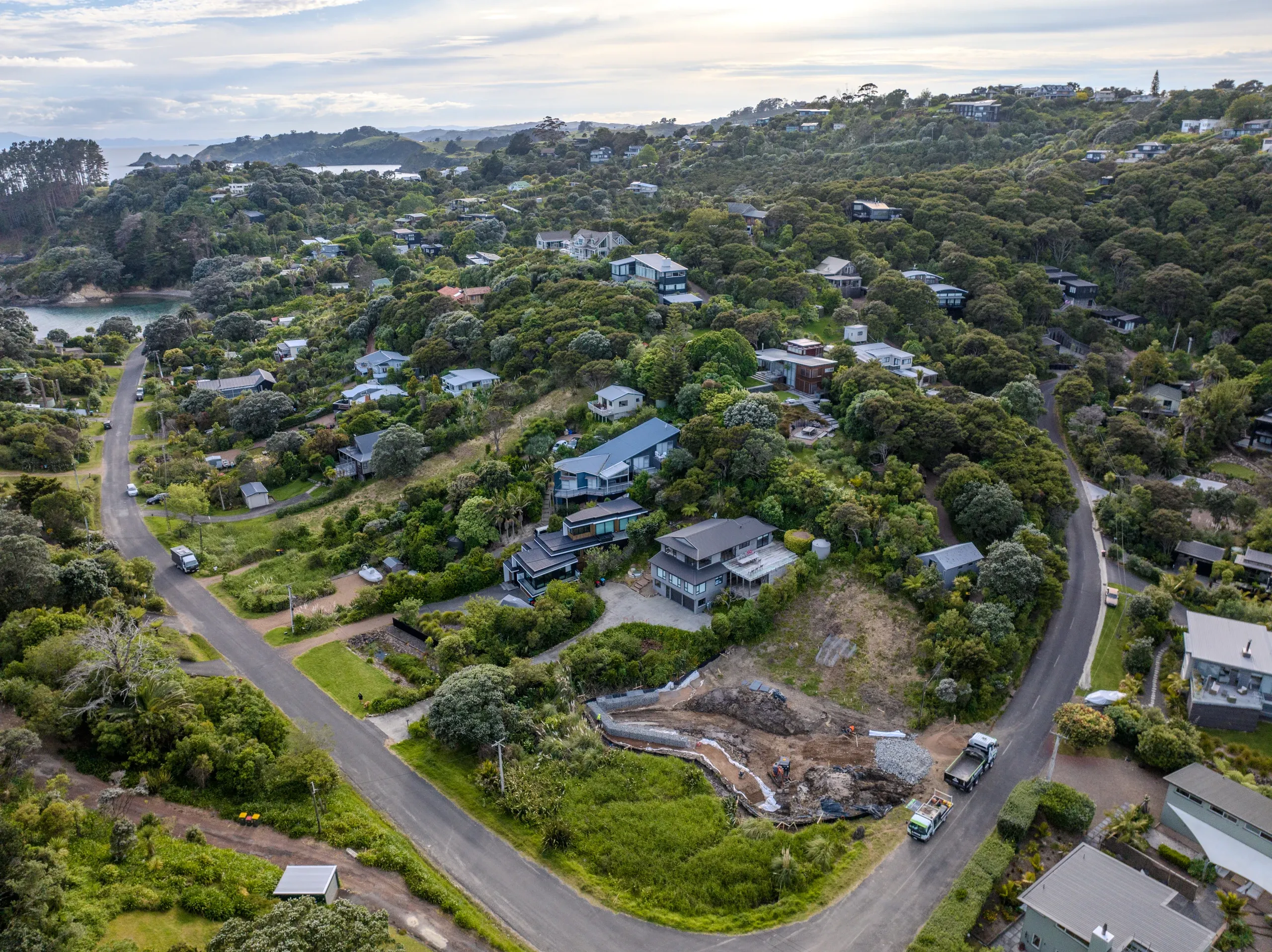 Aerial context shot showing the section within the surrounding Waiheke bush and coastal housing.