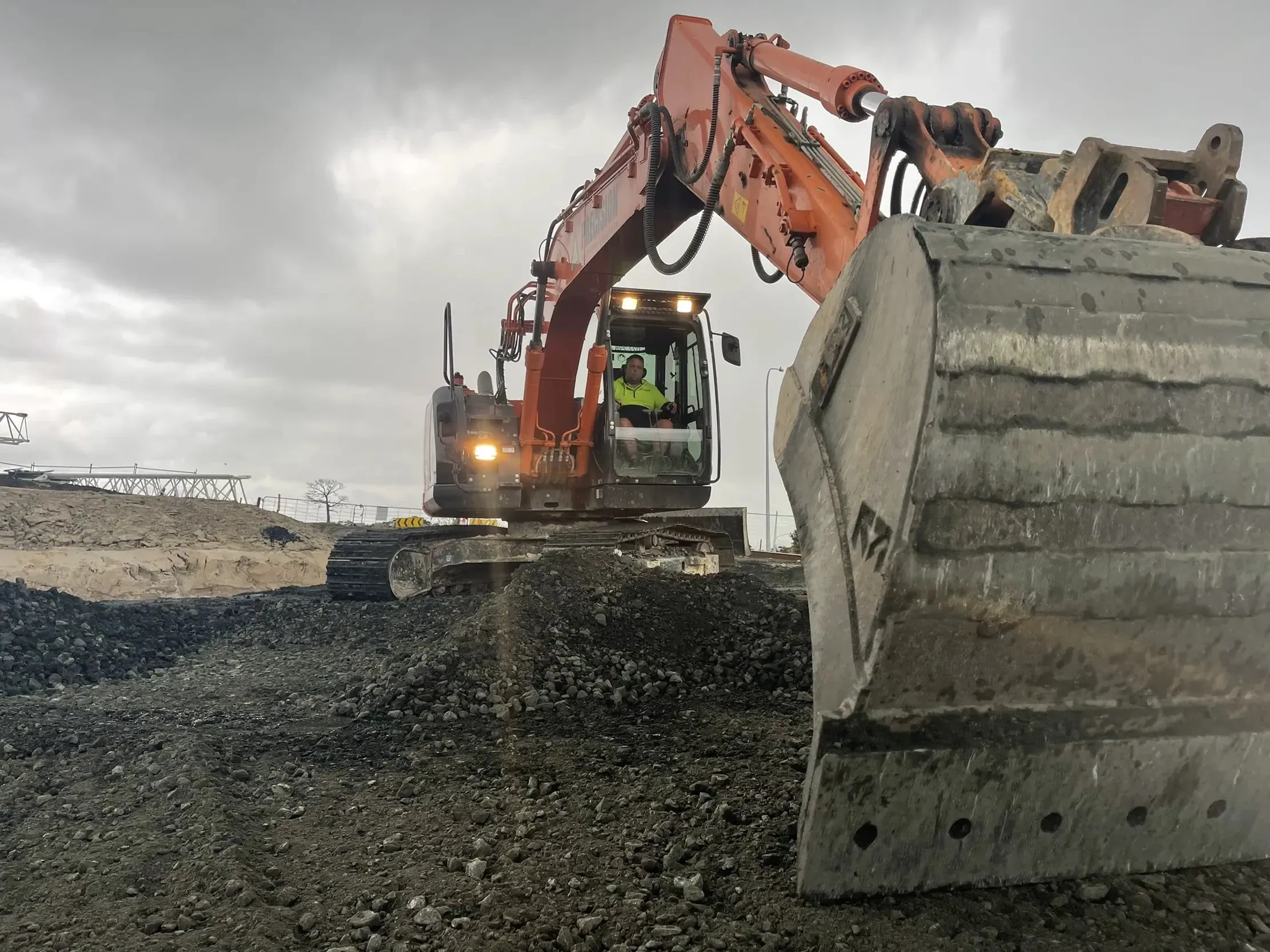 Excavator cutting a site to level during bulk earthworks