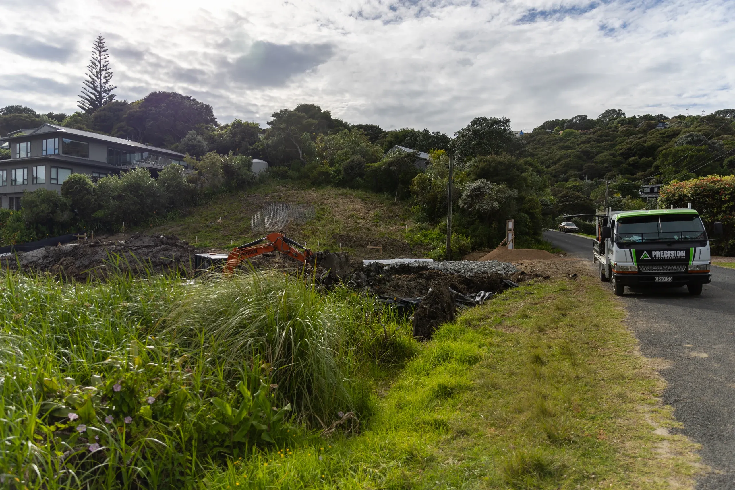 The finished earthworks from the roadside, the new ground level meeting the street cleanly.